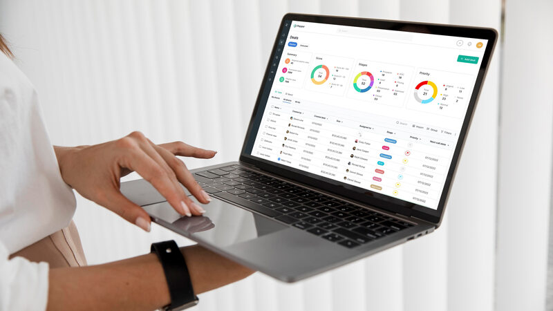 Woman reviewing project dashboard on laptop showing analytics data